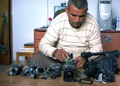Co-director Emad Burnat with his five broken cameras. 