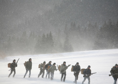 The RLF makes the trek across the mountain through the snow