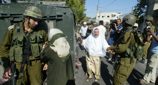 Emad's mother pleads with an Israeli soldier to release her son Khaled after he was arrested.