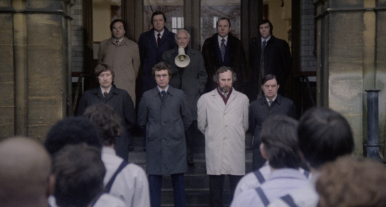 Peter Howell (with megaphone) as the Governor, flanked by his screws in Alan Clarke's SCUM