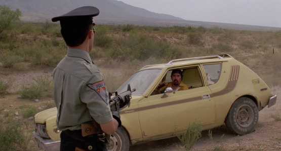 Roberto Sosa as the HIGHWAY PATROLMAN confronts a suspect in Alex Cox's 1991 drama.