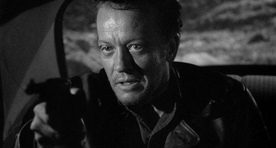 William Talman, as THE HITCH-HIKER, terrorizes everyone he encounters in the classic noir directed by Ida Lupino.