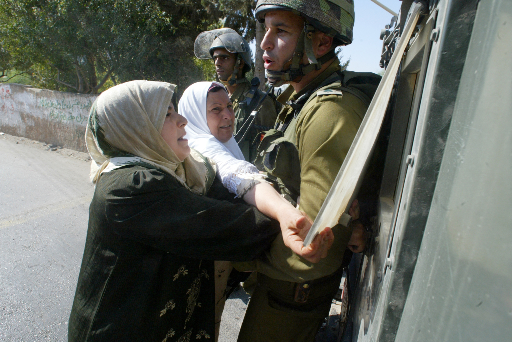 Emad's mother pleads with an Israeli soldier to release her son Khaled after he was arrested.