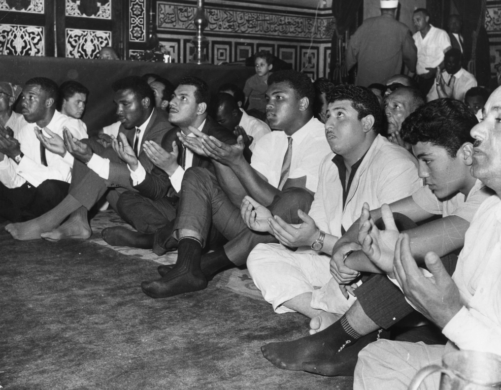 Ali prays at the Hussein Mosque in Cairo in June 1964, four months after changing his name from Cassius Clay and announcing he is a member of the Nation of Islam.
